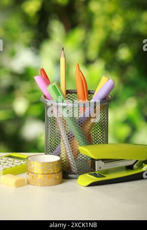 Stapler, holder and other different stationery on white table Stock Photo