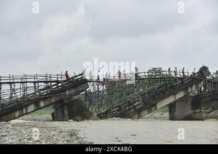 Guwahati, Guwahati, India. 16th June, 2024. Villagers cross a temporary bamboo bridge constructed over Diring river to link a RCC Bridge which has been washed away in flood water in Baksa district of Assam India on Sunday 16th June 2024. (Credit Image: © Dasarath Deka/ZUMA Press Wire) EDITORIAL USAGE ONLY! Not for Commercial USAGE! Stock Photo