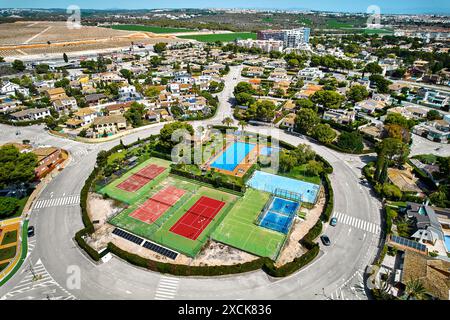 Aerial view Dehesa de Campoamor village, Alicante province, residential area with houses, circular road enclosing park featuring tennis courts, swimmi Stock Photo