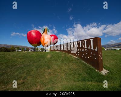 Cromwell, New Zealand - 2024: Apple pear apricot fruit sculpture welcome sign in Cromwell Central Otago South Island New Zealand green grass with blue Stock Photo