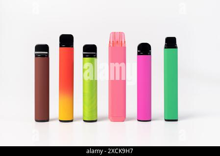 A set of colorful disposable electronic cigarettes of different shapes on a white background. modern smoking Stock Photo