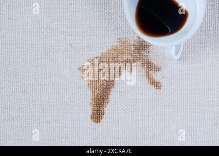 Spilled coffee. A dirty coffee or tea stain on clothes or carpet. Coffee spill ruin piece of furniture. dirty stains in daily life Stock Photo