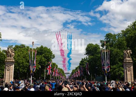 Royal Air Force Red Arrows display team flying over The Mall, London, UK, for the King's Birthday Flypast following Trooping the Colour 2024 Stock Photo