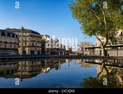 Buildings around Place de la Comedie reflecting in river Lez, Montpellier, Occitania, France Stock Photo