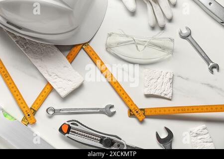 Flat lay composition with different construction tools on white marble background Stock Photo