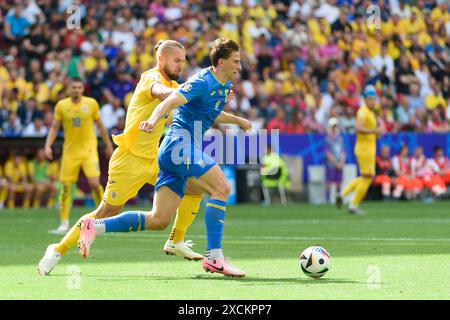 Munich, Germany. 17th June, 2024. Munich, Germany, June 17th 2024: Illya Zabarnyi (13 Ukraine) and George Puşcaş (9 Romania) during the UEFA EURO 2024 Group E football match between Romania and Ukraine at Arena Munich, Germany. (Sven Beyrich/SPP) Credit: SPP Sport Press Photo. /Alamy Live News Stock Photo