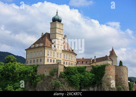 Melk Abbey on the hilltop with a blue cloudy sky - scenic view while cruising on River Danube - Austria Stock Photo