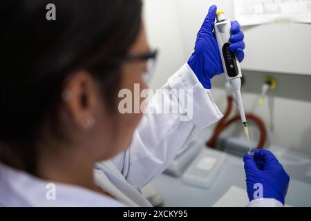 detail of a scientist extracting a liquid sample with a micropipette Stock Photo