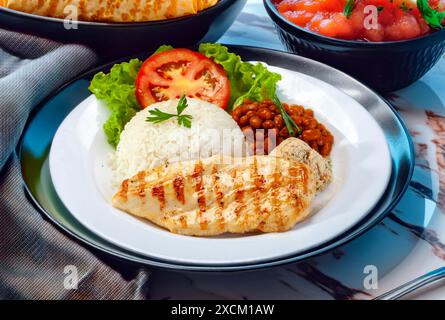 Rice beans grilled chicken steak salad and farofa Stock Photo