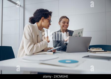 Two female professional executives experts discussing financial accounting papers working together  Stock Photo