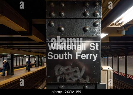 New York, NY – US – June 7, 2024 Commuters gather at Whitehall St South Ferry Subway station in Lower Manhattan, awaiting the next R train, bustling w Stock Photo