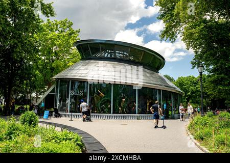 New York, NY – US – June 7, 2024 SeaGlass Carousel offers a mesmerizing journey through an undersea garden, where riders glide on fish crafted from se Stock Photo