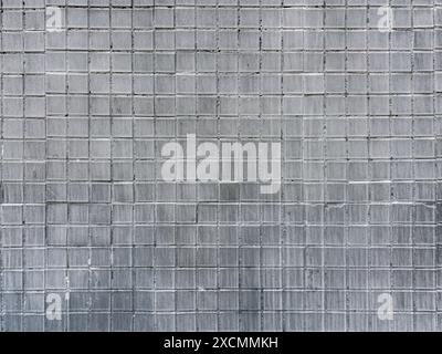 ceramic mosaic tiles wall background painted in gray color. closeup view. Stock Photo