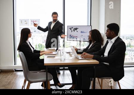 Business man giving presentation to multiracial colleagues Stock Photo