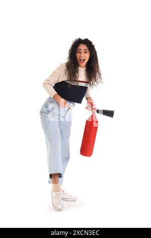 Young African-American woman pointing at fire extinguisher on white background Stock Photo