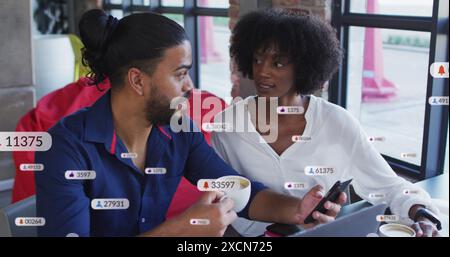 Image of social media icons over diverse business people Stock Photo