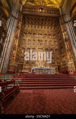 Seville Cathedral interior in Seville, Spain. Main Chapel (Capilla Mayor) and high altar with masterpiece Gothic woodcarving from 1482 to 1564, altarp Stock Photo