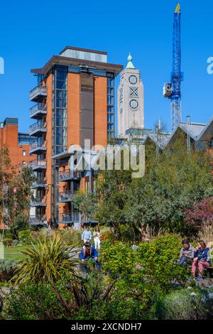 The Oxo Tower & a high-rise residential building with a building crane behind Bernie Spain Gardens, Southbank, London. Stock Photo