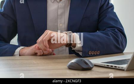businessman looking at classic wristwatch, time management concept Stock Photo