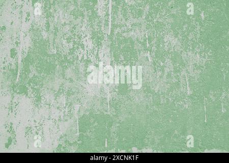 Painted aged green grungy concrete background texture. Abstract wallpaper, shabby distressed stone wall with streaks of paint, vintage stucco surface, Stock Photo