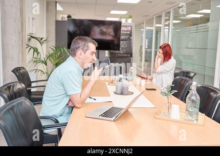 businesspeople in the office using their laptop. young couple in new startup Stock Photo