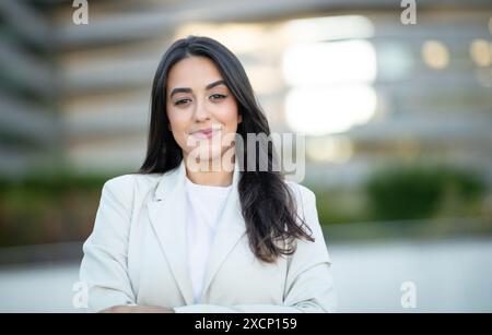 Portrait of Woman Wearing White Blazer in an Outdoor Setting Stock Photo