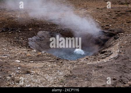 Little Geyser (Litli Geysir) boiling and steaming hot spring in Haukadular valley geothermal area in Iceland, no people. Stock Photo