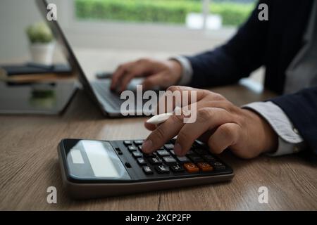 calculate Accounting Business man using calculator Business man using calculator Close-up Stock Photo
