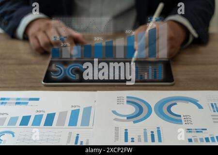 Analyzing business person reports Business  meeting for analysis laptop and graph documents discussing and analyzing and planning Stock Photo