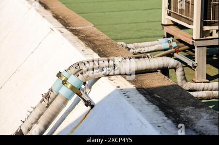 Damaged of plastic corrugated hose or defected of PVC flexible Covered pipe of air condition system. Stock Photo