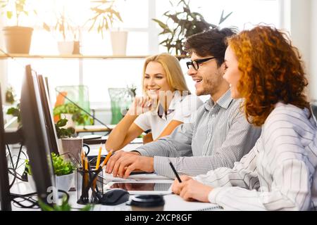Collaborative Team on Laptops at Trendy Workspace Stock Photo