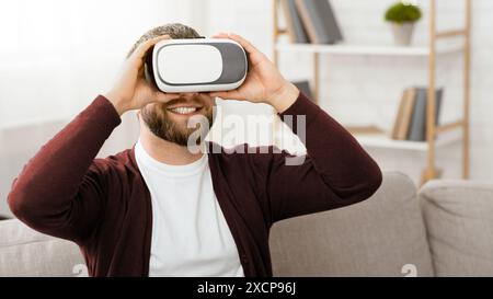 Bearded Man Wearing VR Headset at Home Stock Photo