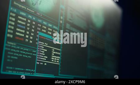 Close up shot of dangerous hacking code running on high tech computer system monitors. Programming scripts shown on PC displays in empty criminal hideout used by hackers to commit illegal activities Stock Photo