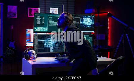 Hacker in hideout interrupted by police sirens from writing malware code on computer, running to escape before getting caught. Criminal den found by anti hacking law enforcement, camera B Stock Photo