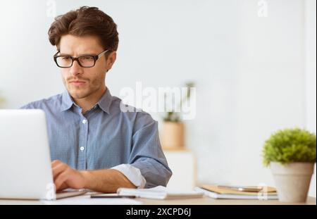Man Working on Laptop in Office Stock Photo