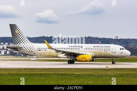 An Airbus A320-232 operated by Vueling Airlines taxies to the runway at Zurich Airport. The aircraft bears the special livery entitled Vueling loves B Stock Photo