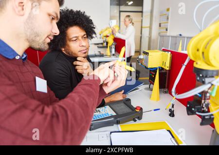 Programming robot controller, Programming robotic arms in factory ...