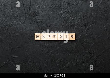 example word written on wood block. example text on table, concept. Stock Photo