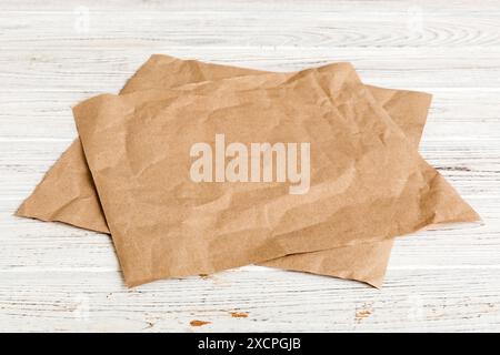 top view with baking parchment empty on table background. Folded cloth for mockup with copy space, Flat lay. Minimal style. Stock Photo