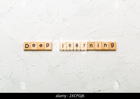 deep learning word written on wood block. deep learning text on cement table for your desing, concept. Stock Photo