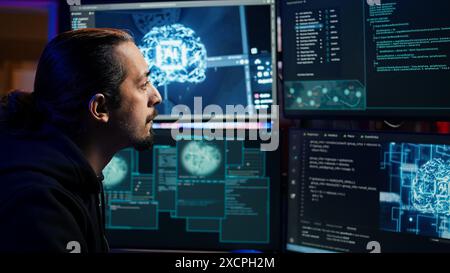 Hacker using AI machine learning on computer to produce malware corrupting data. Scammer working on PC using artificial intelligence tech, infecting systems, close up shot, camera B Stock Photo