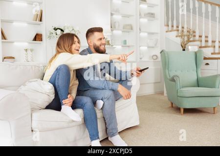 Man and Woman Pointing on Couch Stock Photo