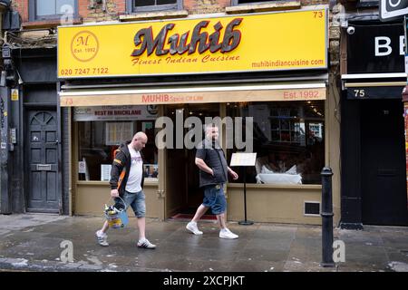 Muhib Indian restaurant on Brick Lane on 25th September 2023 in London, United Kingdom. Brick Lane is a street in the East End borough of Tower Hamlets which runs from Bethnal Green down through Spitalfields to Whitechapel. Today, it is the heart of the countrys Bangladeshi community with the vicinity known to some as Banglatown. Brick Lane is known as a centre for creative people and arts, especially street art and graffiti art, as well as it’s many Bangladeshi / Indian restaurants, known as curry houses. Stock Photo