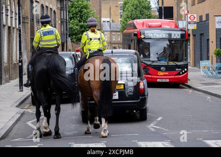 Mounted Metropolitan Police on patrol along Wapping High Street on 13th June 2024 in London, United Kingdom. Statistics show that much of the time the Metropolitan Police Mounted Branch spend most of their time patrolling as opposed to dealing with public order issues. The Metropolitan Police Service, formerly and still commonly known as the Metropolitan Police, is the territorial police force responsible for the prevention of crime and law enforcement in Greater London. The Met was recently put into special measures following criticism over its poor performance. Stock Photo