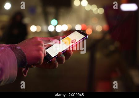 Man using smartphone outdoors, closeup. Spam message notification on device screen, illustration Stock Photo