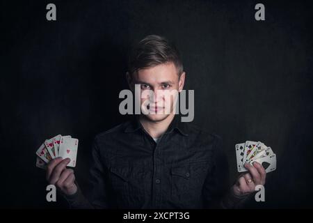 Gambler holding playing cards in both hands. Royal flush successful poker combinations. Casino games tournament advertisement. Lucky gamer or magician Stock Photo