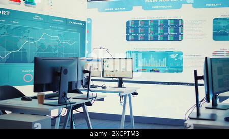 Empty boardroom space with multiple workstations having computers to solve daily business tasks and achieve organizational goals. Enterprise office with big screen for workflow management. Camera B. Stock Photo