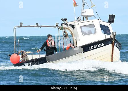 Prime Minister Rishi Sunak rides on a boat in the harbour at Clovelly, as he collects lobster pots, during a visit to North Devon, while on the General Election campaign trail. Picture date: Tuesday June 18, 2024. Stock Photo