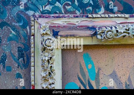 Old worn out frame on a painted wall. Stock Photo
