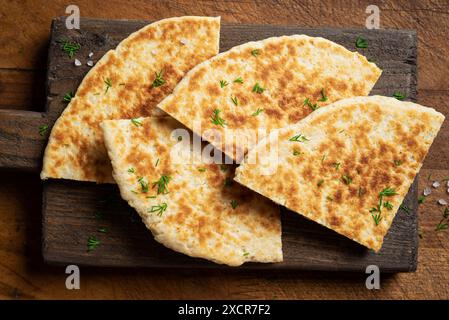Pita bread on wooden background, top view. Georgian or arabian cuisine. Turkish food. Fresh homemade naan flatbread. Mediterranean traditional breakfa Stock Photo